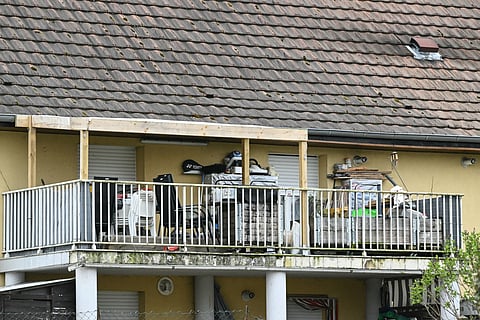 A photo shows the involved suspects' terrace at the first level of a residential building where which a boy was discovered in the courtyard naked and malnourished on a pile of rubbish in a van where he had been kept locked up, in Hagenbach, eastern France, on April 10, 2026.