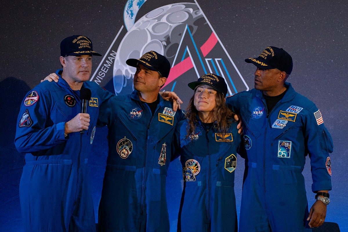 Artemis II Mission Specialist Jeremy Hansen, Mission Specialist Christina Koch, Pilot Victor Glover, and Commander Reid Wiseman embrace during a press conference on April 11, 2026 at Ellington Field Joint Reserve Base in Houston, Texas.