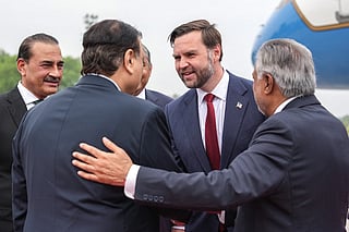 US Vice President JD Vance (2R) shakes hands with a Pakistani official as Army Chief and Field Marshal Syed Asim Munir (L) and Pakistan's Foreign Minister Ishaq Dar (R) watche upon his arrival for the US-Iran peace talks in Islamabad on April 11, 2026.