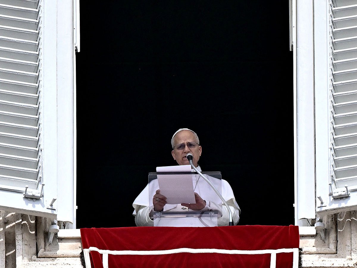 Pope Leo XIV addresses the crowd from the window of the apostolic palace overlooking St. Peter's square during the Regina Caeli prayer in The Vatican on April 12, 2026.