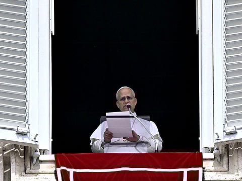 Pope Leo XIV addresses the crowd from the window of the apostolic palace overlooking St. Peter's square during the Regina Caeli prayer in The Vatican on April 12, 2026.