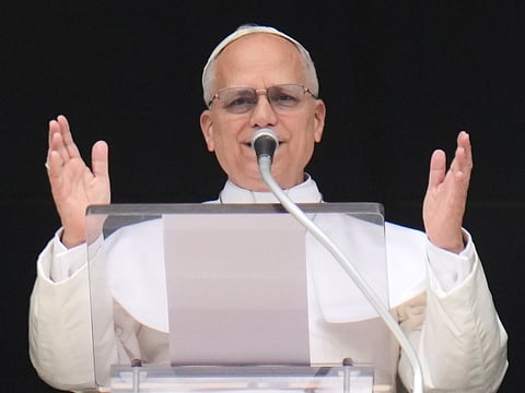 Pope Leo XIV addresses the crowd from the window of the apostolic palace overlooking St. Peter's square during the Regina Caeli prayer in The Vatican on April 12, 2026.