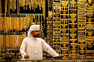 An gold dealer stands in a jewelry shop in the Dubai Gold Souk earlier this week.