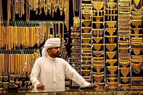 An gold dealer stands in a jewelry shop in the Dubai Gold Souk earlier this week.