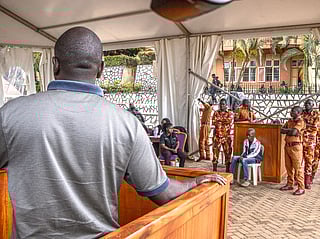 A parent (L) of one of the victims in the Ggaba killings, offers his testimony to the events during the anticipated public trial of Christopher Okello Onyum (4th R), suspected in the killing of four toddlers at a daycare in Ggaba, at the Ggaba Community Church Grounds in Kampala on April 13, 2026.