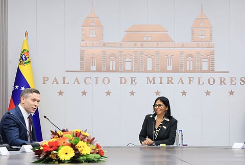 Handout picture released by Venezuelan Presidency shows Venezuela's interim President Delcy Rodriguez meeting with US Assistant Secretary of Energy Kyle Haustveit at Miraflores presidential palace in Caracas om April 14, 2026.