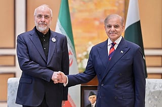 Iran's Parliament Speaker Mohammad Bagher Ghalibaf, left, with Pakistani Prime Minister Shehbaz Sharif prior to their meeting, in Islamabad, Pakistan, Saturday, April 11, 2026.  