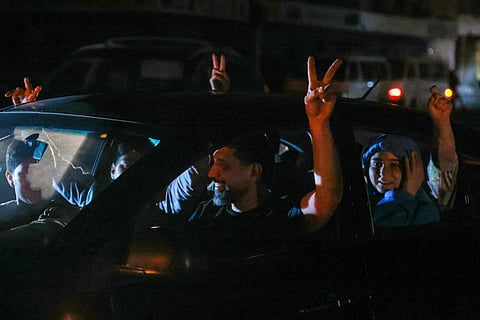 Supporters of Hezbollah celebrate the ceasefire with Israel as it takes effect, in the southern suburbs of Beirut, Lebanon, on April 17, 2026.