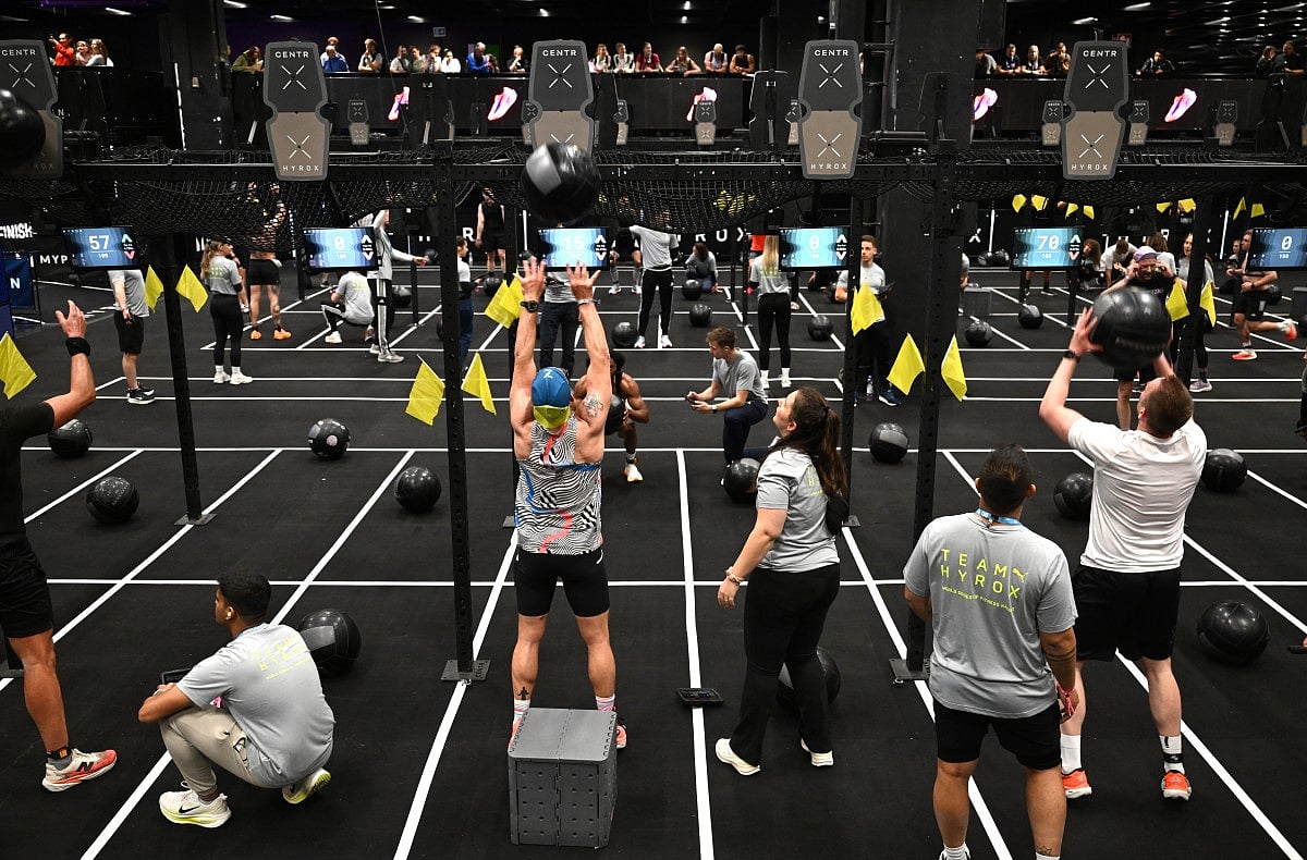 Visitors perform during indoor fitness competition Hyrox event at the FIBO trade show for health, fitness and wellness in Cologne, western Germany on April 16, 2026.