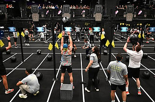 Visitors perform during indoor fitness competition Hyrox event at the FIBO trade show for health, fitness and wellness in Cologne, western Germany on April 16, 2026.