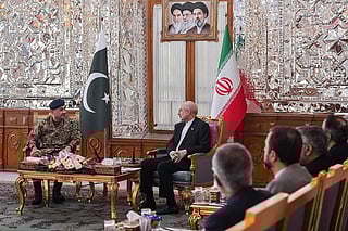 This handout photo taken and provided by the Office of Iranian Parliament Speaker on April 16, 2026 shows Iranian Parliament speaker Mohammad Bagher Ghalibaf (C) speaking with Pakistan's Army Chief Asim Munir (L) during their meeting in Tehran.