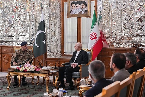 This handout photo taken and provided by the Office of Iranian Parliament Speaker on April 16, 2026 shows Iranian Parliament speaker Mohammad Bagher Ghalibaf (C) speaking with Pakistan's Army Chief Asim Munir (L) during their meeting in Tehran.