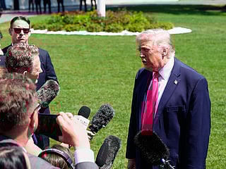 President Donald Trump speaks with reporters before departing on Marine One from the South Lawn of the White House.
