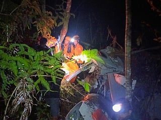 Rescuers inspect the wreckage of a helicopter that crashed in Sekadau, West Kalimantan, Indonesia. 