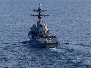 The guided-missile destroyer USS Michael Murphy (DDG 112) patrols the Arabian Sea on Friday, April 17, as US forces enforce a naval blockade on vessels attempting to enter or leave Iranian ports. 