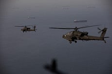 AH-64 Apaches flying above the Strait of Hormuz during a patrol on April 17, 2026.  