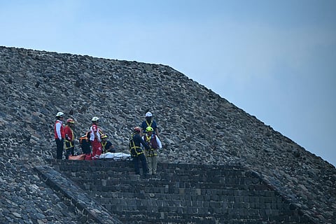 Forensic experts and members of the Red Cross transport a body on the Pyramid of the Moon at the Teotihuacan archaeological zone following a shooting in Teotihuacan, State of Mexico, on April 20, 2026.