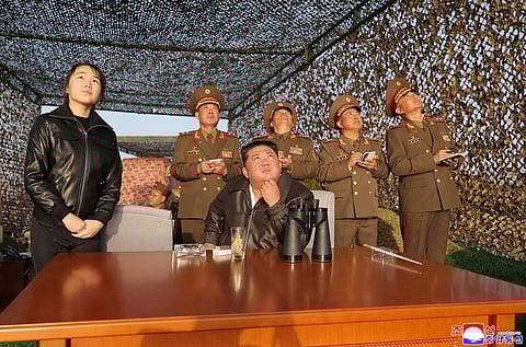 In this photo provided by the North Korean government, its leader Kim Jong Un, sitting, with his daughter observes what it says a test launch of an upgraded surface-to-surface ballistic missile at an undisclosed place in North Korea Sunday, April 19, 2026. Independent journalists were not given access to cover the event depicted in this image distributed by the North Korean government. The content of this image is as provided and cannot be independently verified. Korean language watermark on image as provided by source reads: "KCNA" which is the abbreviation for Korean Central News Agency. (Korean Central News Agency/Korea News Service via AP)