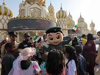A Dubai police mascot with kids at season 30 of Global Village which reopened after a month-long pause.  