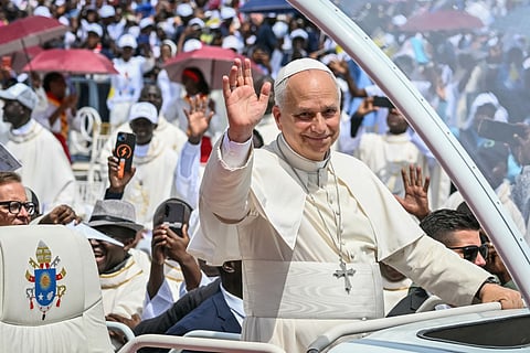 Pope Leo XIV waves to the crowd from the Popemobile as he arrives to lead the Holy Mass at the Saurimo esplanade in Saurimo on the eighth day of an 11-day apostolic journey to Africa, on April 20, 2026.