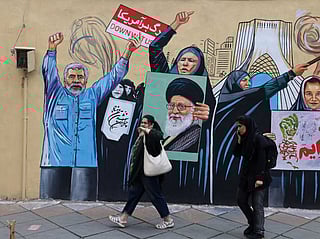 Iranians walk past an anti-USA and anti-Israel mural depicting the late Iranian supreme leader Ayatollah Ali Khamenei, in Tehran on April 21 2026, amid a ceasefire in the region.