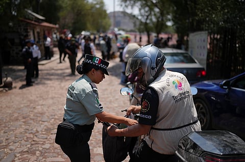 Police search visitors at the Teotihuacan pyramids as the archaeological site reopened two days after a gunman opened fire killing a Canadian tourists, outside Mexico City, Wednesday, April 22, 2026. (AP Photo/Eduardo Verdugo)