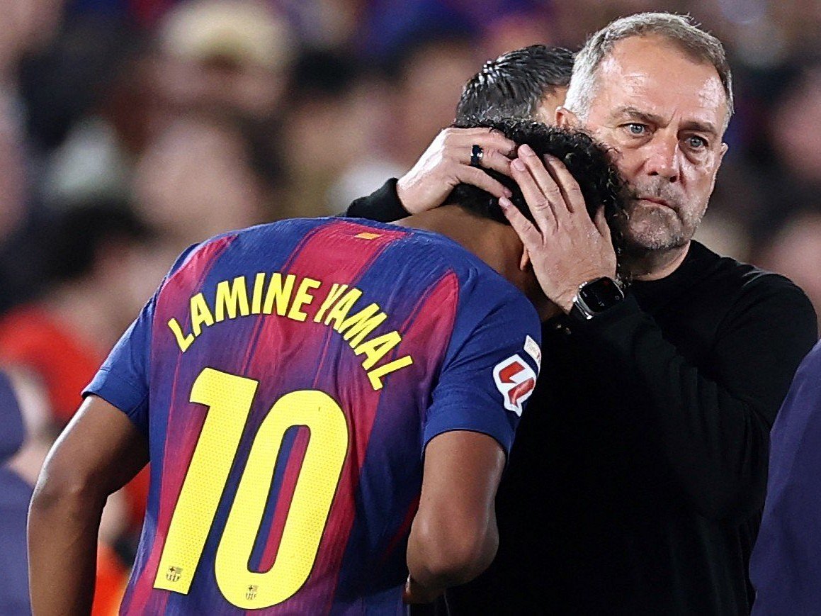 Barcelona's German coach Hans-Dieter Flick hugs Lamine Yamal as he is substituted due to injury