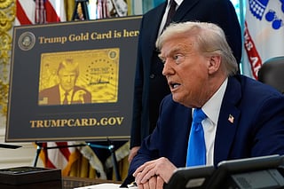 FILE - A poster showing the Trump Gold Card is seen as President Donald Trump signs executive orders in the Oval Office of the White House, Sept. 19, 2025, in Washington. (AP Photo/Alex Brandon, File)