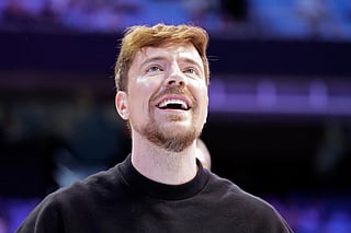 FILE - YouTube personality MrBeast, aka Jimmy Donaldson, watches a contestant's shot in a free throw shooting contest that he sponsored at the conclusion of of an NCAA college basketball game between USC Upstate and North Carolina, Dec. 13, 2025, in Chapel Hill, N.C. (AP Photo/Chris Seward, File)