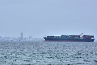 A container ship is seen in the Strait of Hormuz off the coast of Qeshm Island, Iran, Saturday, April 18, 2026.