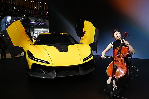 China’s top automakers unveil cutting-edge models and technology at the Beijing Auto Show, highlighting advances in intelligent driving, ultrafast charging, and electric vehicles. More than 1,450 vehicles are on display, including 181 global debuts. Above, a musician plays next to a Dreame Nebula Next 01 concept car at the Beijing Auto Show in Beijing.