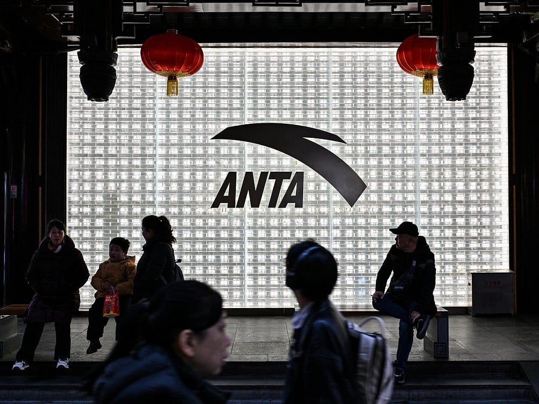 People walk past an Anta store in the Huangpu district of Shanghai 