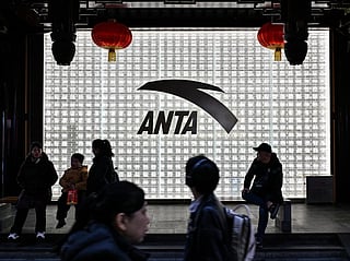 People walk past an Anta store in the Huangpu district of Shanghai 