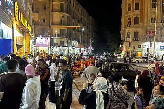 People are seen out at night in downtown Cairo on April 28, 2026.