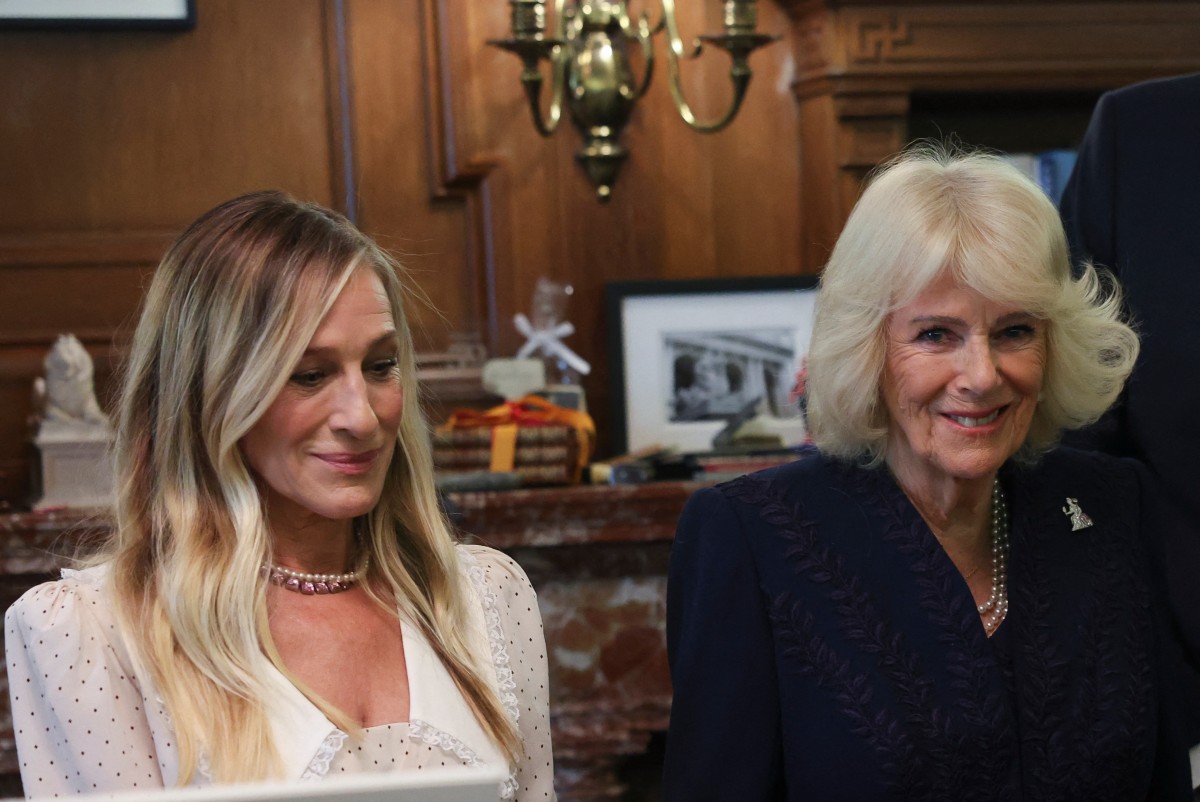 Britain’s Queen Camilla smiles next to US actresss Sarah Jessica Parker during a visit to the New York Public Library for a literary event in New York City on April 29, 2026.
