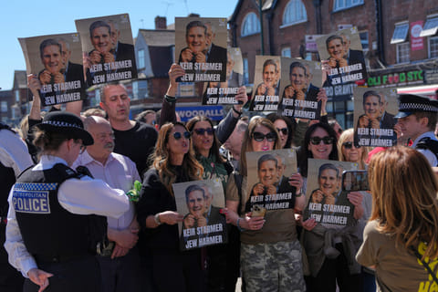 Protesters hold posters near the scene where two people were stabbed yesterday in the Golders Green neighbourhood, that has a large Jewish community, in London, Thursday, April 30, 2026.(AP Photo/Alastair Grant) (Photo: AP)