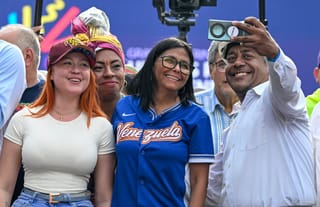 Venezuela's acting president Delcy Rodriguez (C) poses for a selfie with supporters during a march calling for the lifting of all US sanctions in Caracas on April 30, 2026.