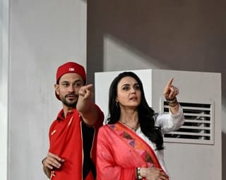 Bollywood actress and Punjab Kings' co-owner Preity Zinta (2R) gestures alongside actor Kunal Khemu (2L) before the start of the 2026 Indian Premier League (IPL) T20 match between Punjab Kings and Rajasthan Royals at the Maharaja Yadavindra Singh International Cricket Stadium on the outskirts of Chandigarh on April 28, 2026.