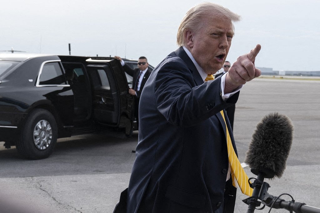 President Donald Trump speaks to journalists before boarding Air Force One at Palm Beach International Airport on May 2, 2026 in Palm Beach, Florida.