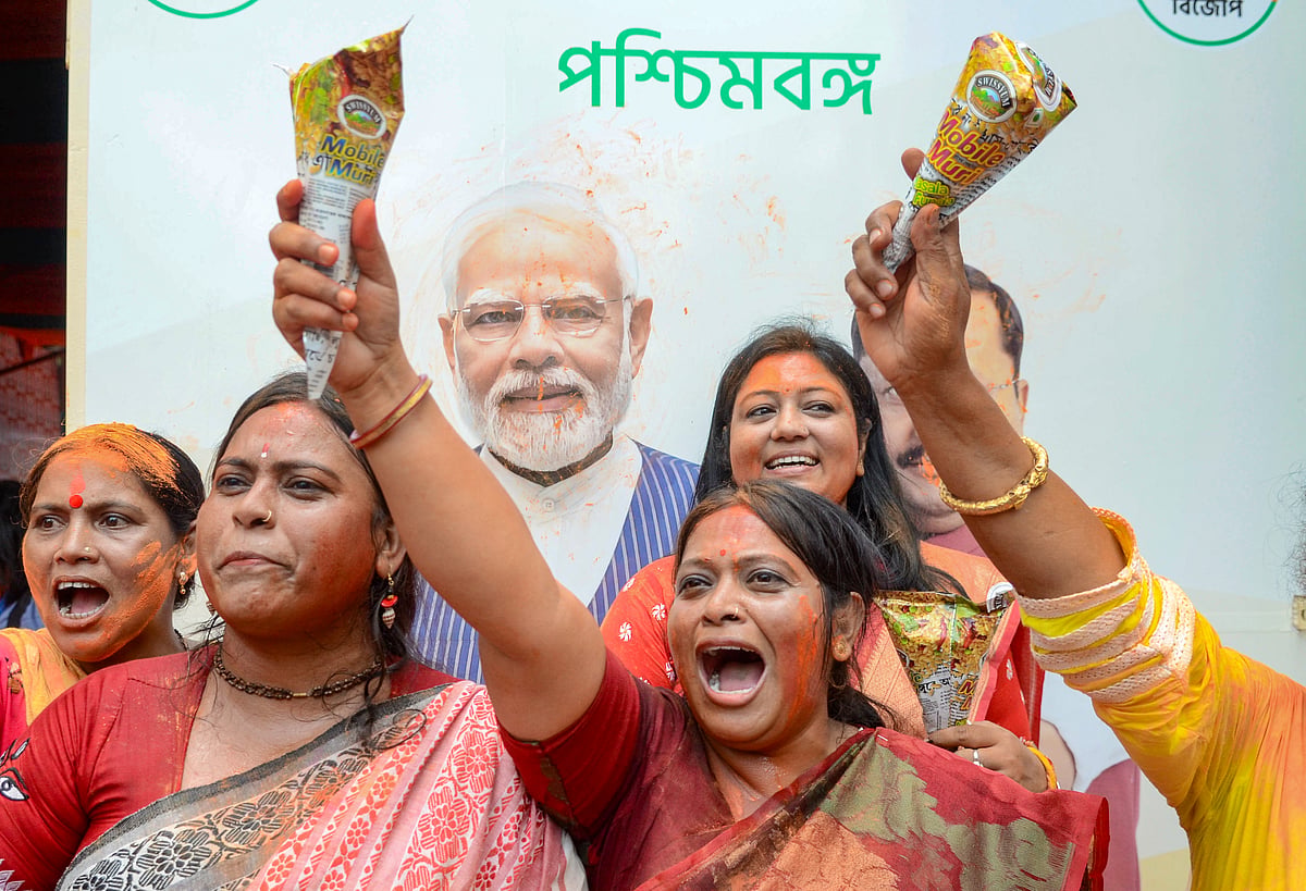 BJP workers celebrate the party's lead during the counting of votes for the West Bengal Assembly elections in Kolkata on Monday, May 4, 2026.