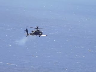 An Apache attack helicopter fires a "Hellfire" missile. On Monday, the US military said it destroyed six small boats in Hormuz area and intercepted Iranian cruise missiles and drones as Tehran sought to impose its toll system over the strait.