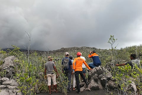 A handout picture taken and released on May 8, 2026 by Indonesia's National Search and Rescue Agency (BASARNAS) shows rescue workers standing by after the volcanic eruption of Mount Dukono in North Halmahera, North Maluku.
