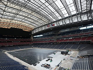 Workers install the first layer of the new playing surface at Houston Stadium, on Friday, May 8, 2026, in Houston, ahead of the 2026 FIFA World Cup soccer matches. 