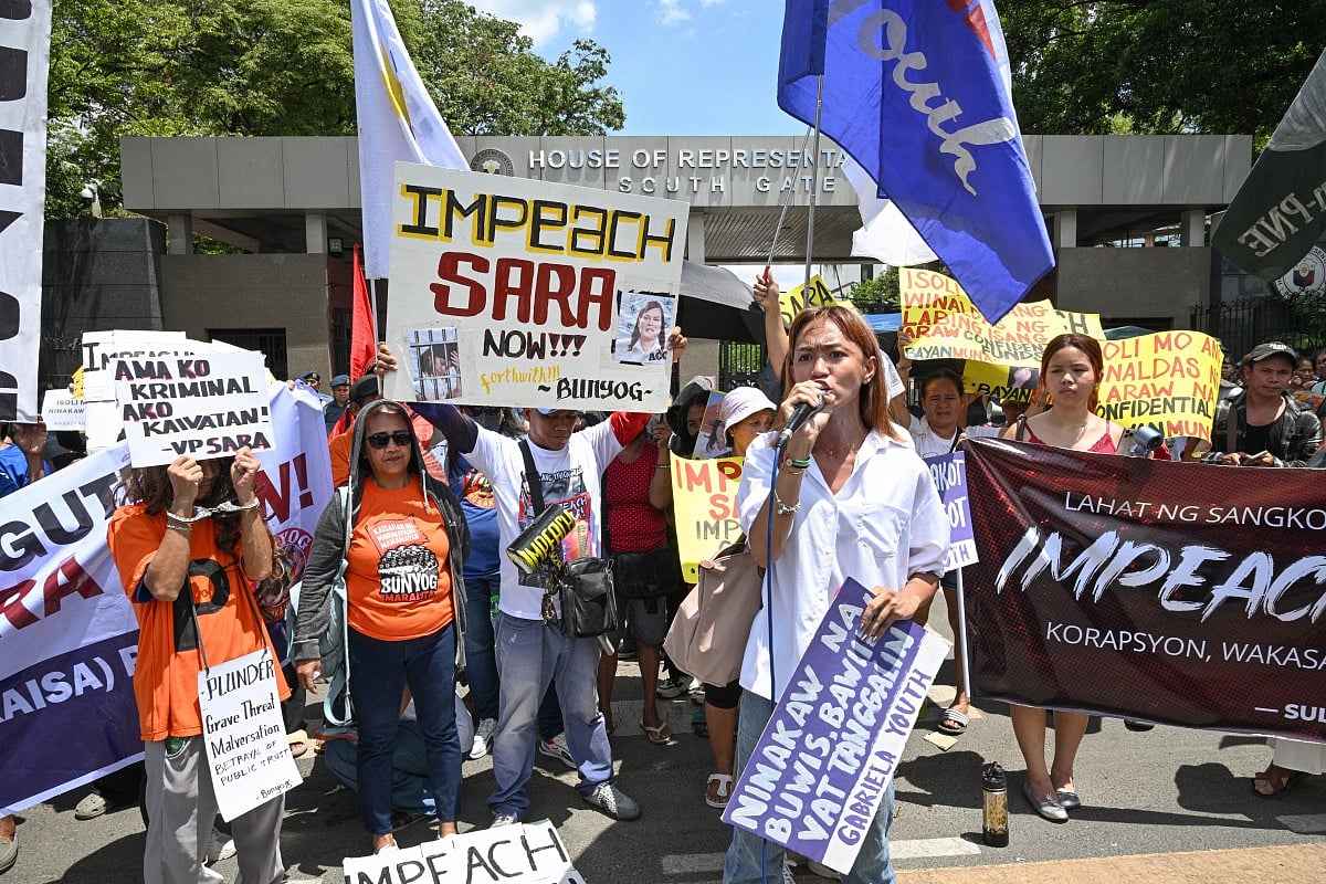 Protesters from progressive groups hold placards during a protest in support of the impeachment of Philippine Vice-President Sara Duterte in front of the Congress building in Quezon City, Metro Manila on May 11, 2026.