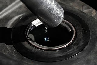 FILE - Gasoline drops from the nozzle of a fuel pump as it fills a motorcycle as prices continue to rise at a gasoline station in Quezon City, Philippines on March 19, 2026. (AP Photo/Aaron Favila, File)
