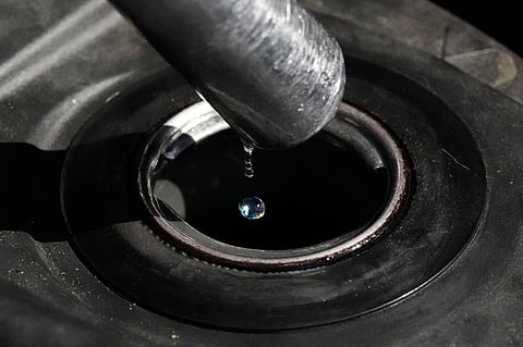 FILE - Gasoline drops from the nozzle of a fuel pump as it fills a motorcycle as prices continue to rise at a gasoline station in Quezon City, Philippines on March 19, 2026. (AP Photo/Aaron Favila, File)