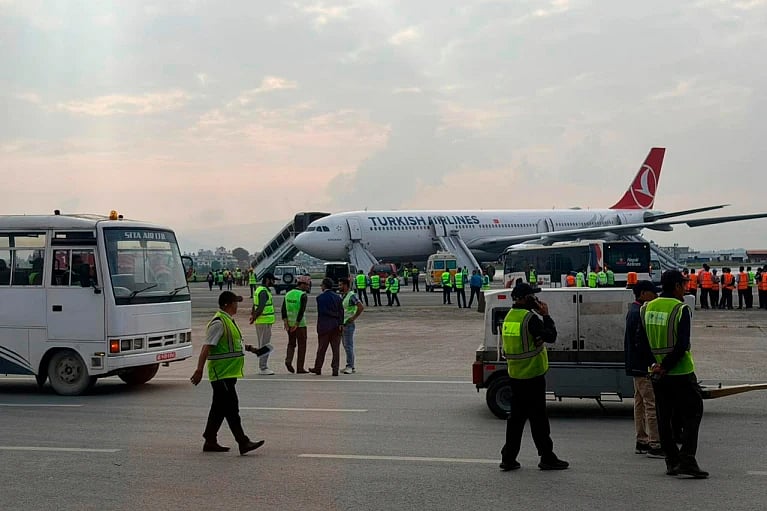A Turkish Airlines aircraft is seen after passengers were safely evacuated following a fire on the jet while landing in Kathmandu.