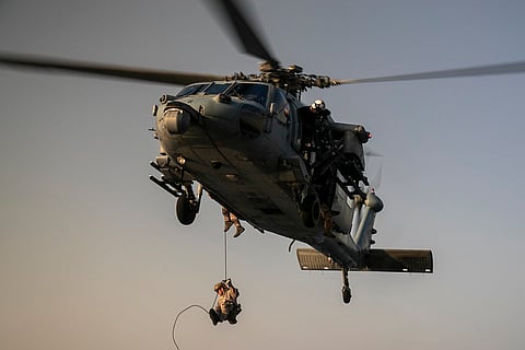 US Marines fast-rope from an MH-60S Seahawk helicopter during a maritime interdiction training exercise. Recent weeks have seen US and Iranian forces trade limited strikes and naval confrontations in and around the waterway, raising fears in global markets about the vulnerability of energy supplies. 

