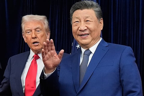 Chinese President Xi Jinping, right, waves, with President Donald Trump, ahead of their summit talk at Gimhae International Airport in Busan, South Korea. File photo taken on Oct. 30, 2025.