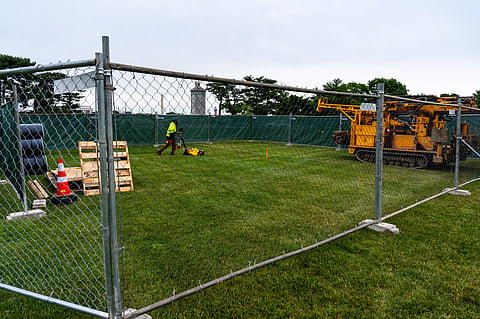 Workers survey the Memorial Circle, where President Donald Trump has proposed building an arch to commemorate the United States' 250th anniversary, Monday, May 11, 2026, in Washington. (AP Photo/Alex Brandon)